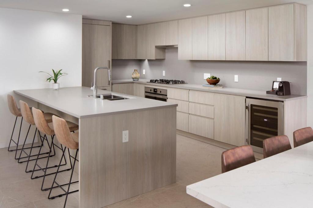 a kitchen with a large island with bar stools at Level Seattle Downtown South Lake Union in Seattle