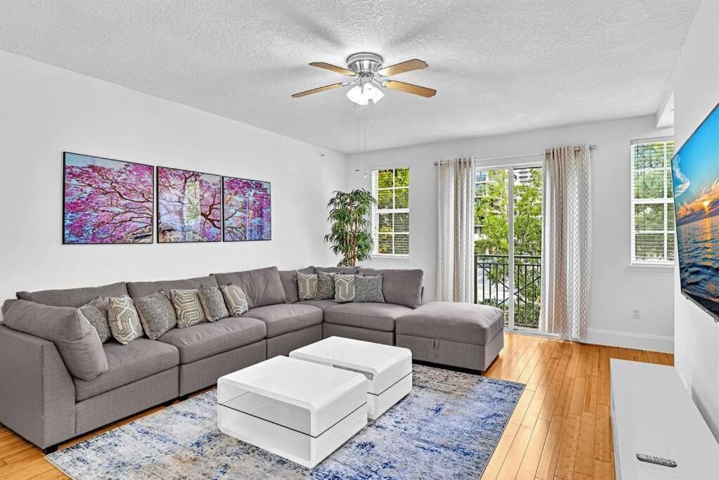 a living room with a couch and a ceiling fan at Gorgeous Townhouse Beach Access Resort Amenities in Hallandale Beach