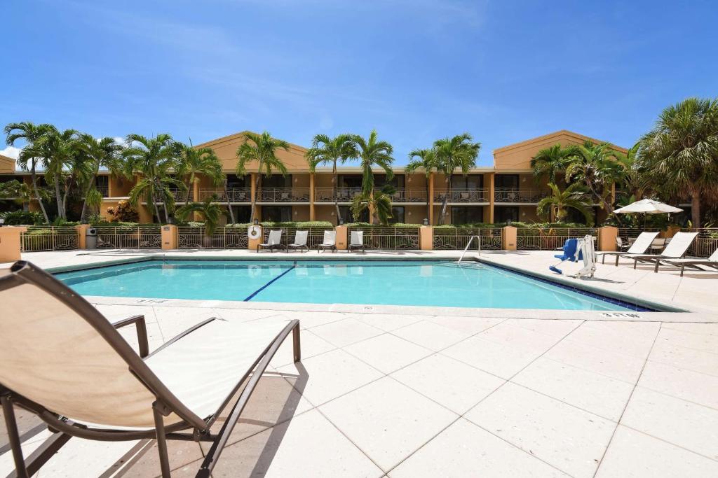 a swimming pool with two lawn chairs at Hampton Inn Key Largo in Key Largo