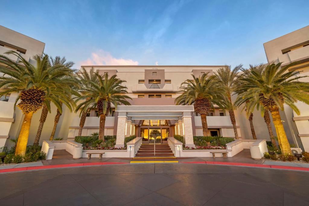 a building with palm trees in front of it at Hilton Vacation Club Cancun Resort Las Vegas in Las Vegas