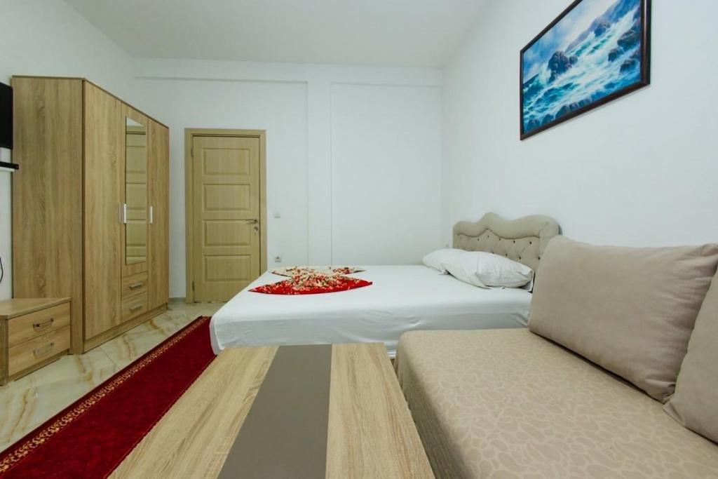 Postel nebo postele na pokoji v ubytování Flori Apartments