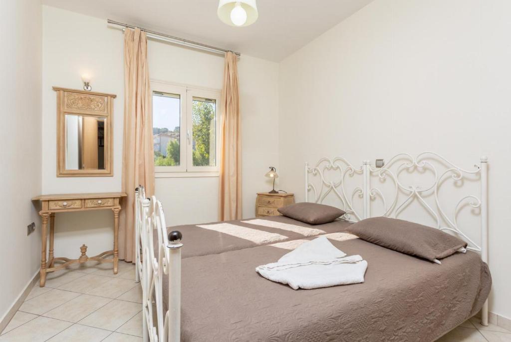 A bed or beds in a room at Katelios Villas Collection
