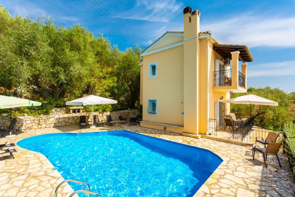 a villa with a swimming pool and a house at Villa Evie in Nisakion