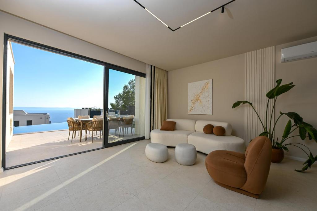 a living room with a couch and a large window at Villa Rosemary in Makarska