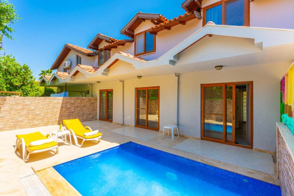 a villa with a swimming pool and a house at Villa Derya Paradise in Dalyan