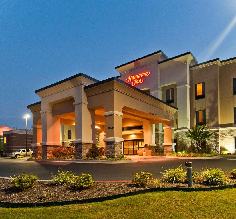 a hotel with a sign that reads embassy inn at Hampton Inn Maumelle in Maumelle