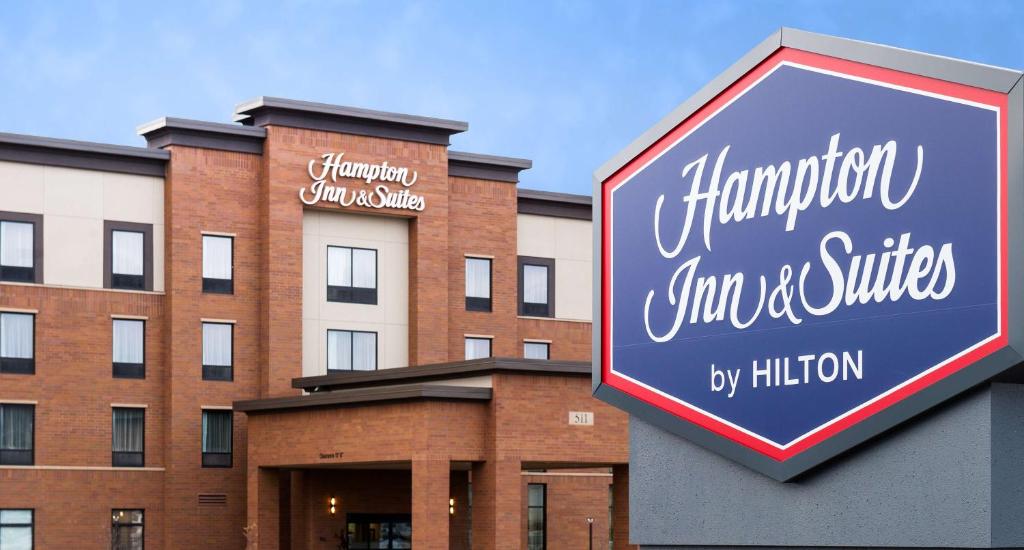 a sign for hampton inn and suites in front of a building at Hampton Inn and Suites La Crosse Downtown in La Crosse