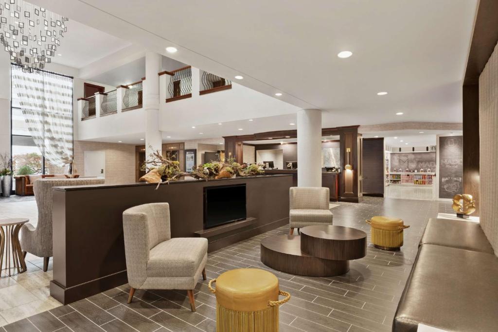 a lobby of a hotel with a bar and chairs at DoubleTree by Hilton McLean Tysons in Tysons Corner