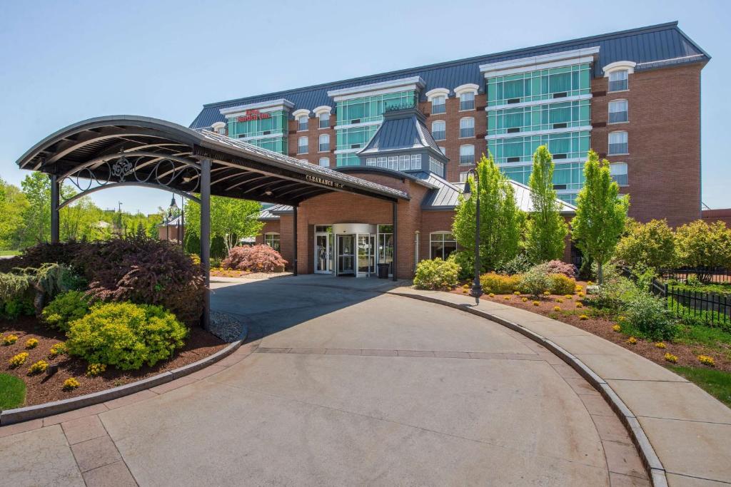 a building with a walkway in front of a building at Hilton Garden Inn Manchester Downtown in Manchester