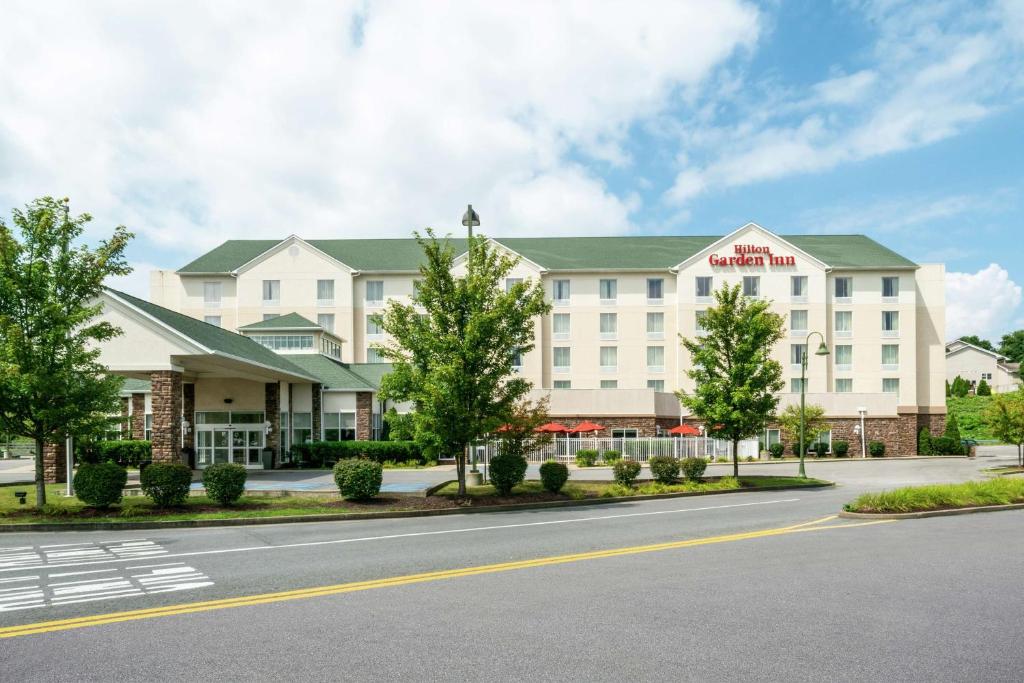 a rendering of a hotel with a road in front at Hilton Garden Inn Morgantown in Morgantown
