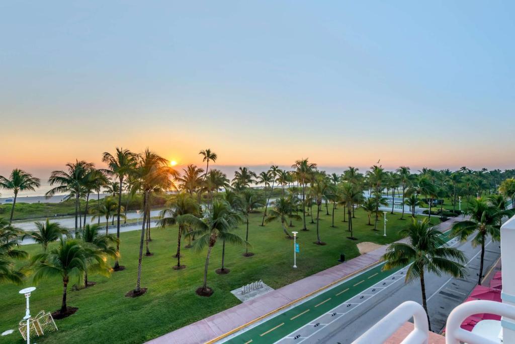 an aerial view of a resort with a pool and palm trees at Hilton Vacation Club Crescent on South Beach Miami in Miami Beach