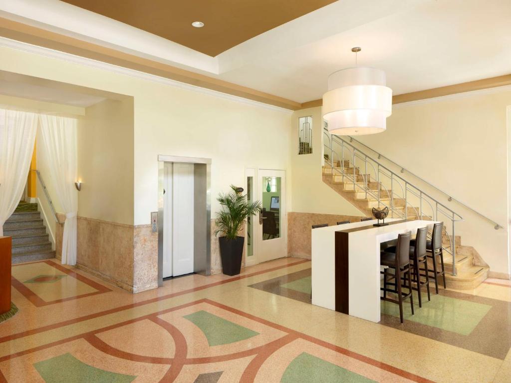 a living room with a staircase and a table at Hilton Vacation Club Crescent on South Beach Miami in Miami Beach