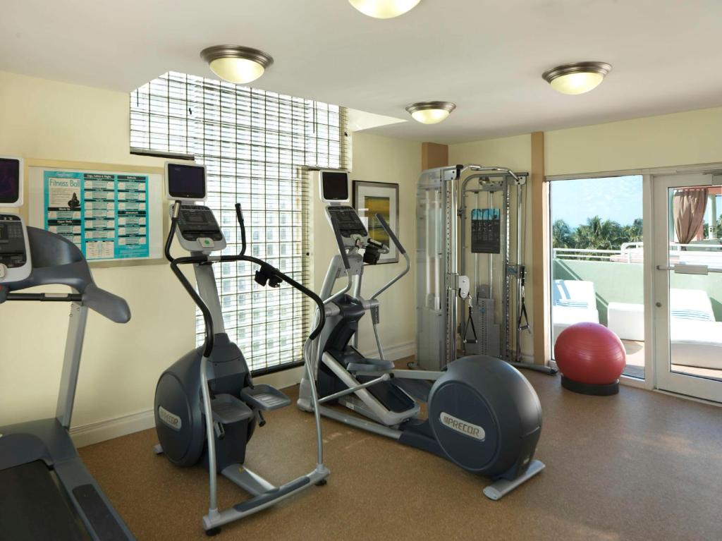 a gym with two treadmills and two exercise bikes at Hilton Vacation Club Crescent on South Beach Miami in Miami Beach
