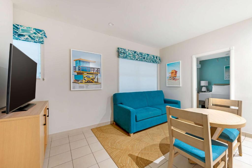 a living room with a blue couch and a table at Hilton Vacation Club Crescent on South Beach Miami in Miami Beach
