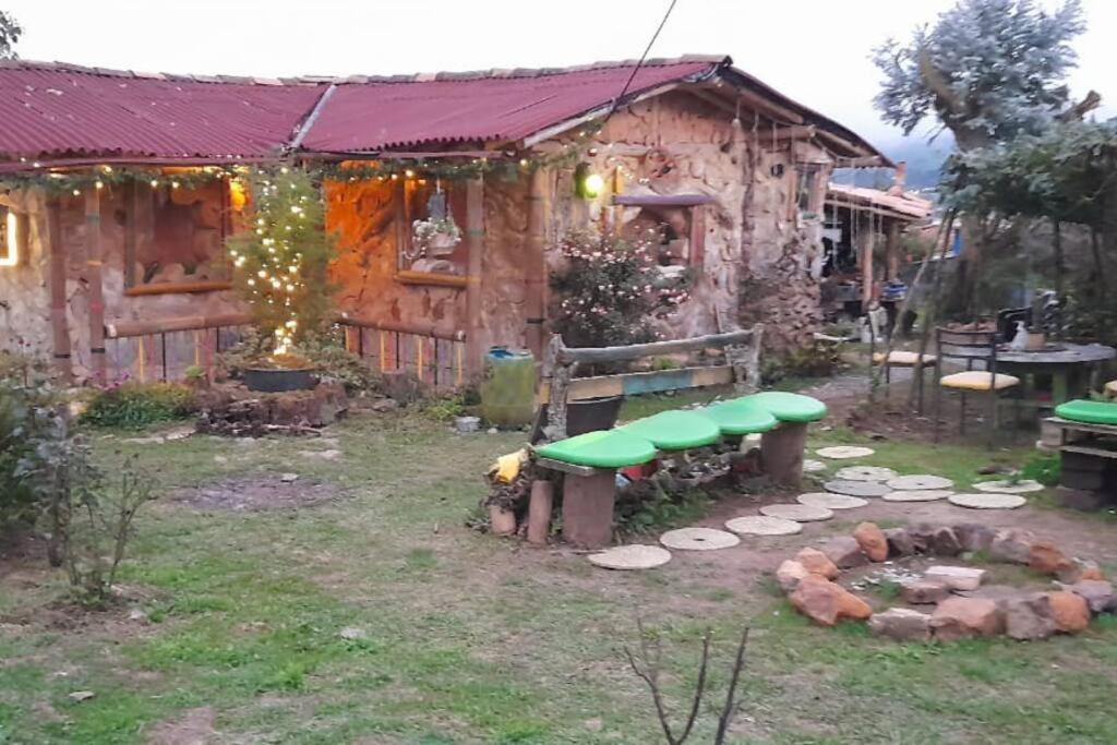 a backyard with a picnic table and a fire place at Aldea Victoria. in Santa Elena
