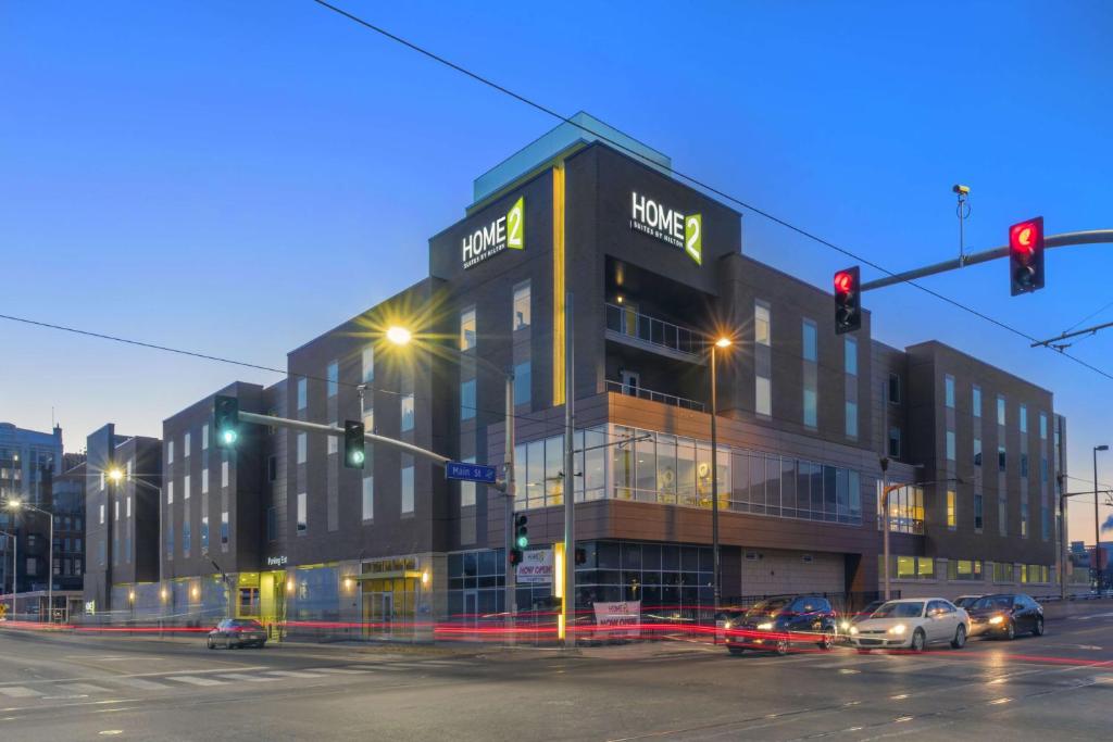 a large building on a city street with traffic lights at Home2 Suites Kansas City Downtown in Kansas City