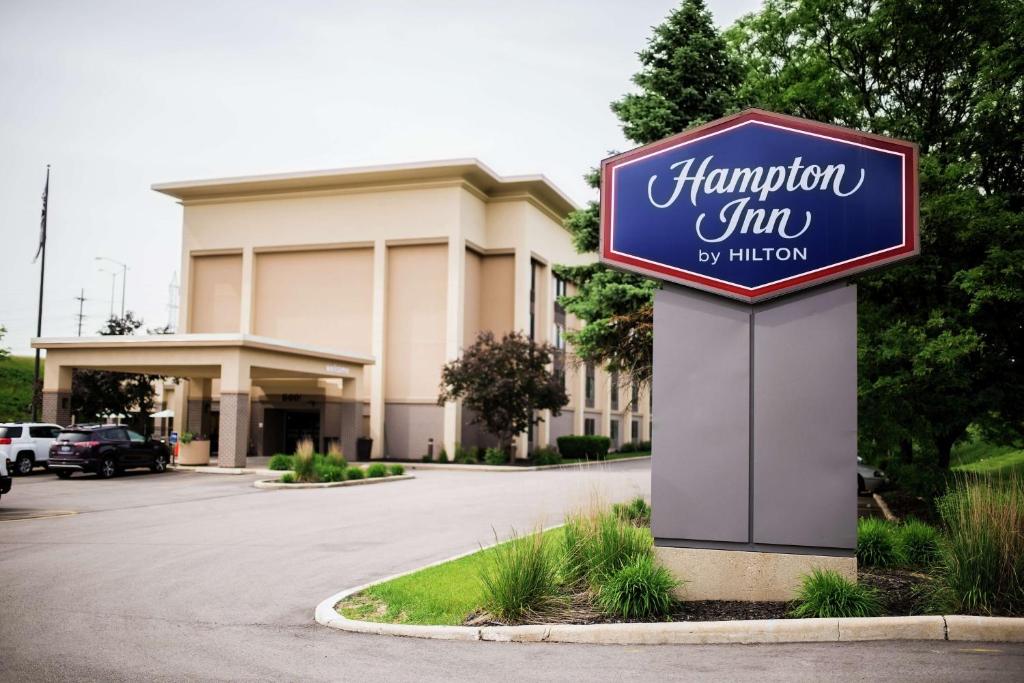 a sign for a hampton inn in front of a building at Hampton Inn Milwaukee Northwest in Milwaukee