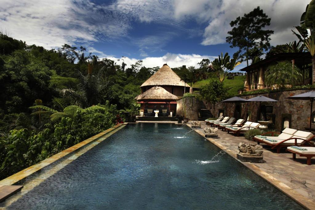 a swimming pool with a gazebo and a resort at Bagus Jati Health & Wellbeing Retreat in Tegalalang