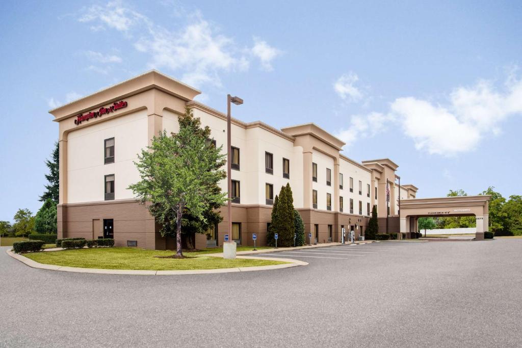 a large white building with a sign on it at Hampton Inn & Suites Nashville-Smyrna in Smyrna