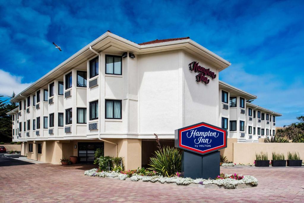 a hotel with a sign in front of a building at Hampton Inn Monterey in Monterey