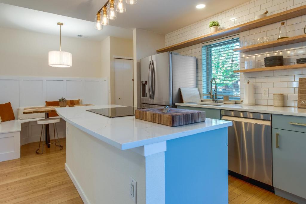 a kitchen with a large island with a refrigerator at Stylish Denver Retreat - Near City Center! in Denver