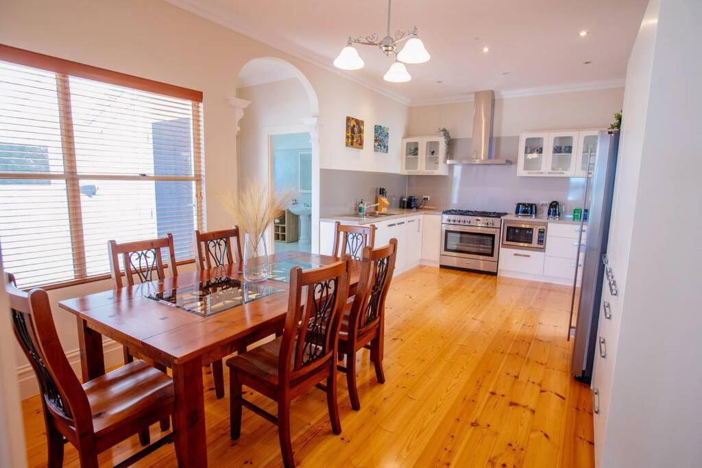 a kitchen with a dining room table and chairs at Selby House in Albany