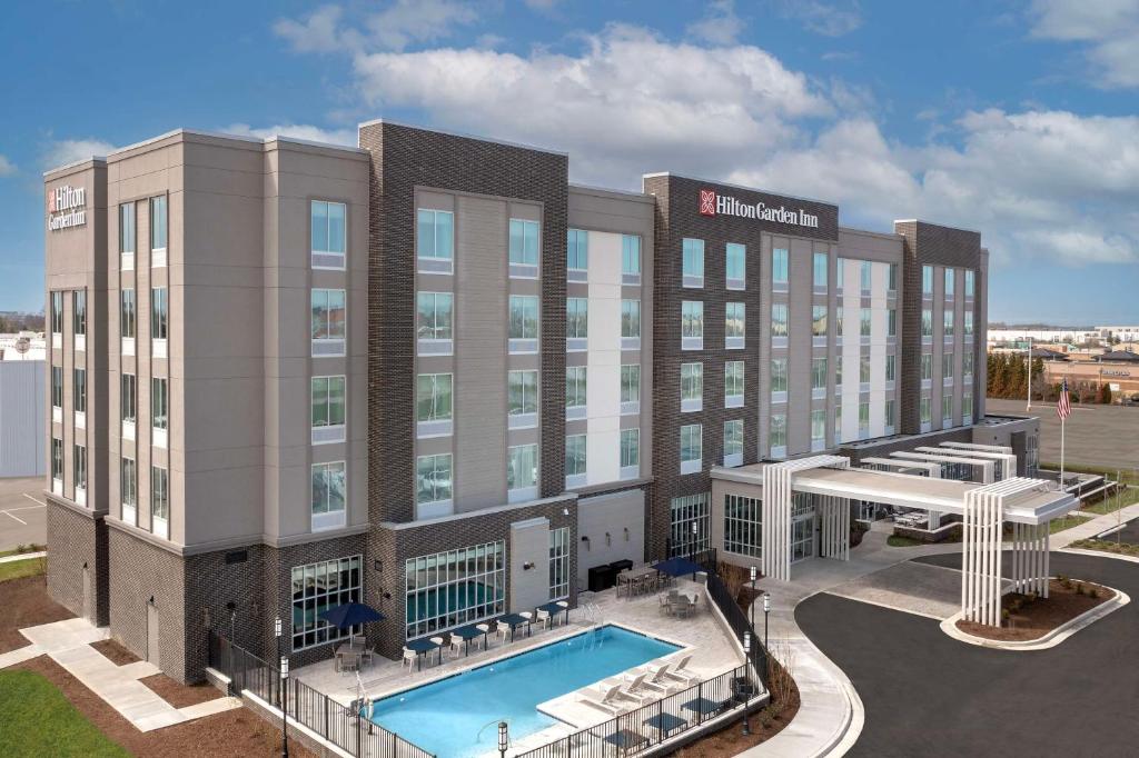 a rendering of a hotel with a swimming pool at Hilton Garden Inn Florence Cincinnati Airport South in Florence