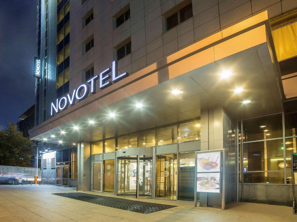 a novation sign on the front of a building at night at Novotel Ekaterinburg Center in Yekaterinburg