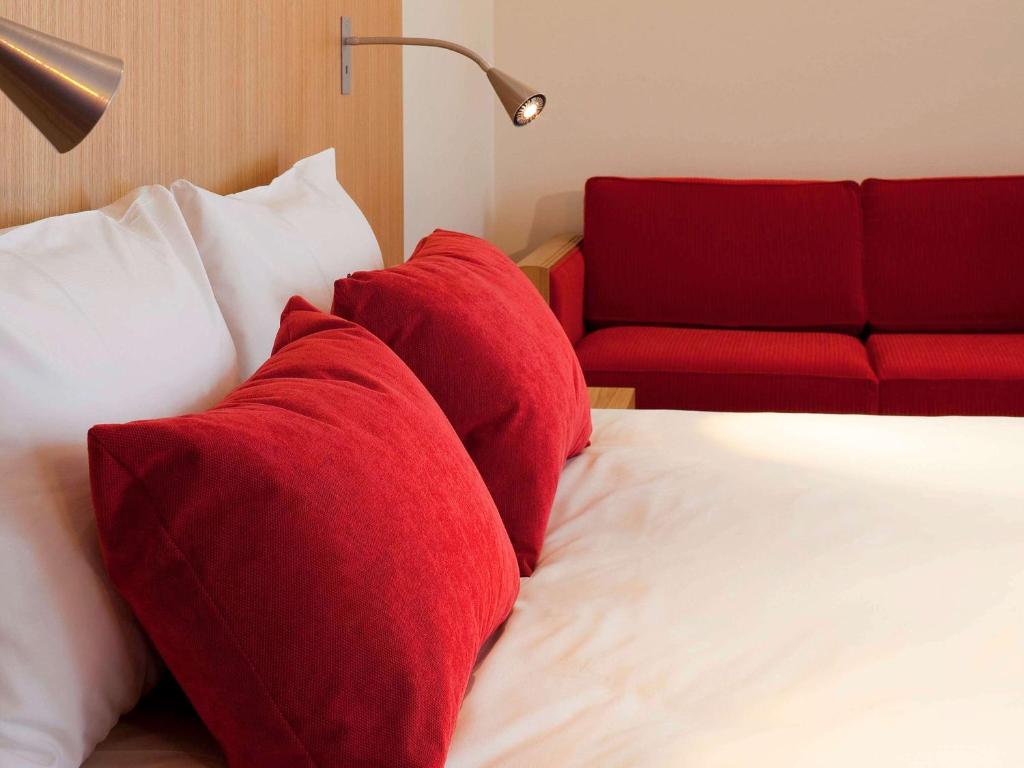 Postel nebo postele na pokoji v ubytování Hôtel Mercure Vittel