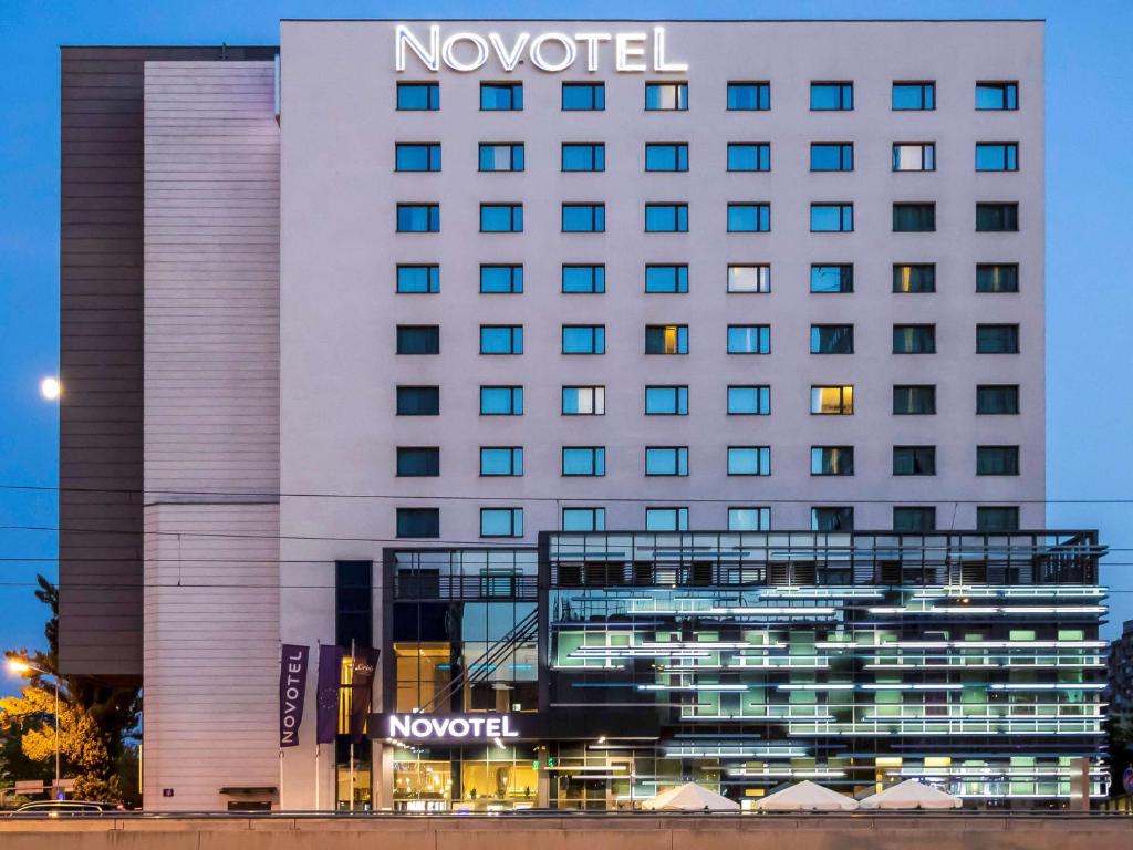 a hotel with a sign on the side of it at Novotel Lodz Centrum in Łódź