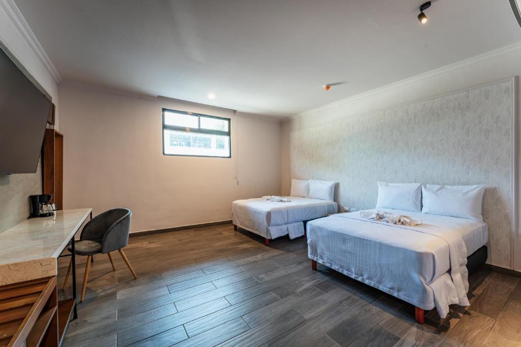 Postel nebo postele na pokoji v ubytování Hotel MID Project