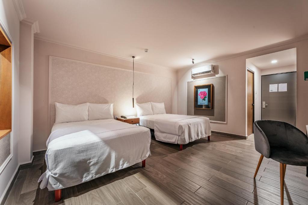 Postel nebo postele na pokoji v ubytování Hotel MID Project