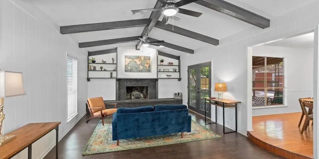 a living room with a blue couch and a fireplace at Small Town, Big House - Sleeps 8! in Taylor