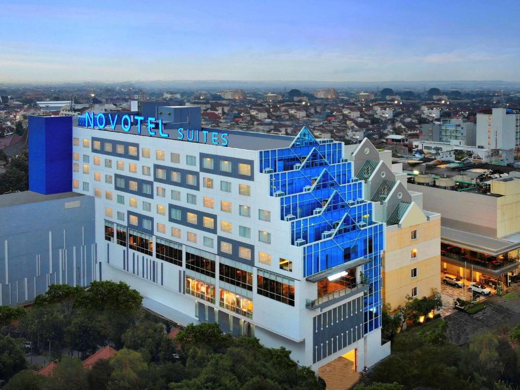 an aerial view of a building with blue windows at Novotel Suites Yogyakarta Malioboro in Yogyakarta