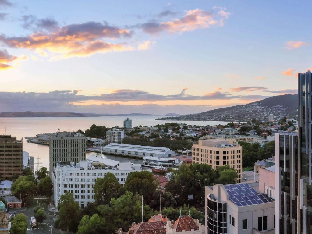 a view of a city skyline at sunset at Mövenpick Hotel Hobart in Hobart