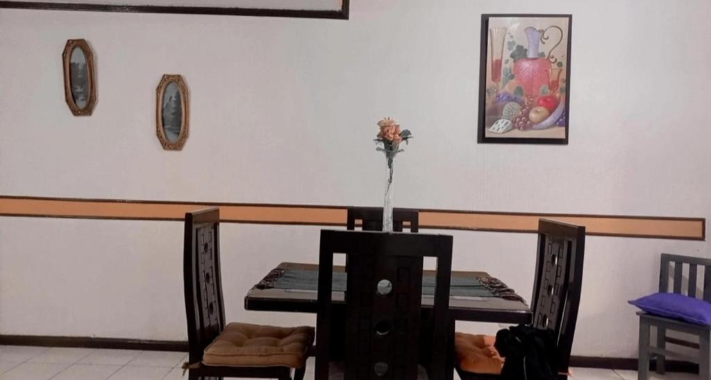 a dining room with a table and a table and chairs at Casa Celeste in Morelia
