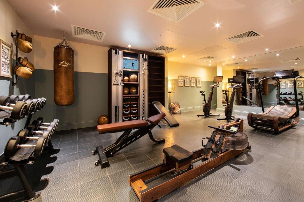a gym with many different kinds of exercise equipment at Holmes Hotel London in London