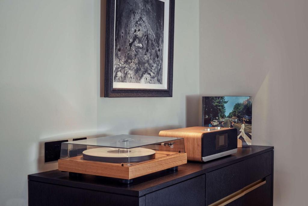 a desk with a tv on top of it at Holmes Hotel London in London