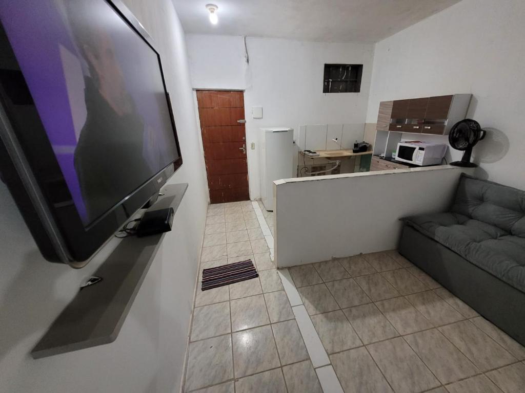 a living room with a large flat screen tv on a wall at ADE águas claras 01 in Brasilia