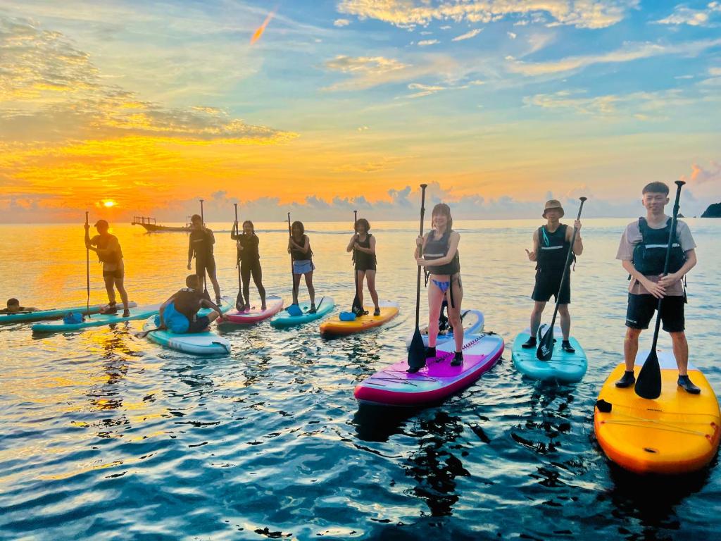 a group of people on paddle boards in the water at 東澳海安獨木舟背包客棧Hai An 2 Hostel in Suao