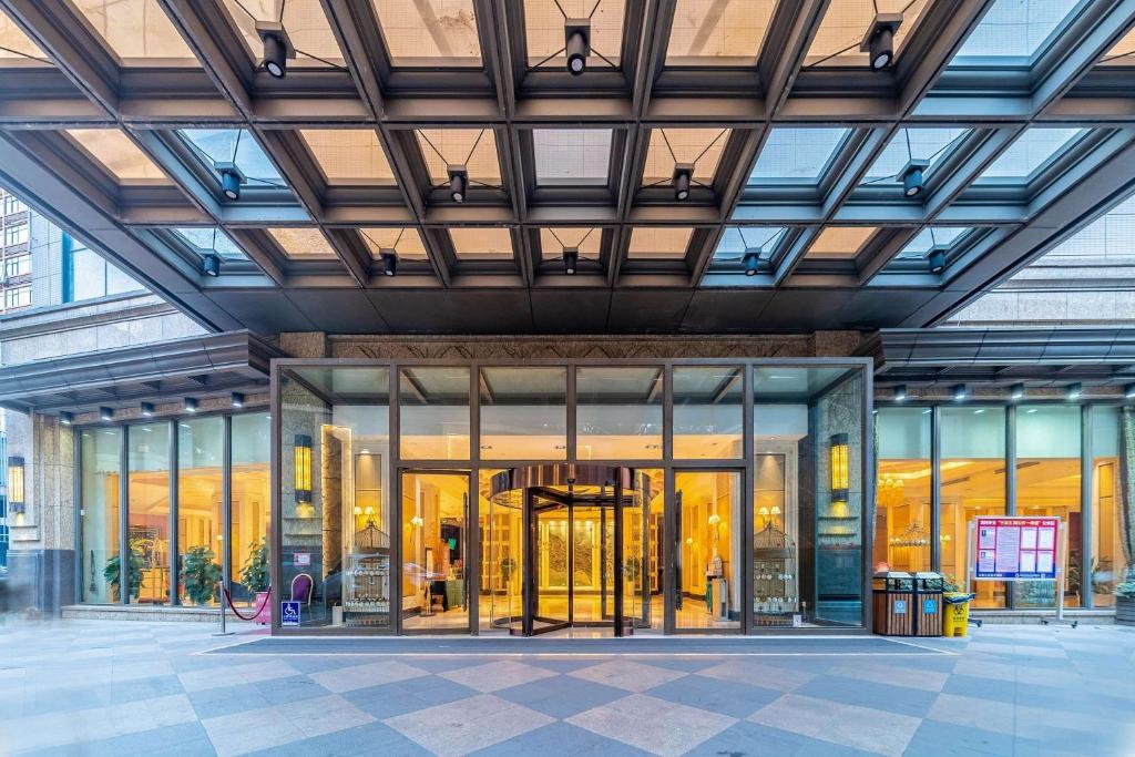 a large building with glass doors and windows at Ramada Yichang Hotel in Yichang