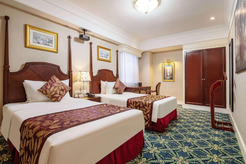 Postel nebo postele na pokoji v ubytování Ramada Yichang Hotel