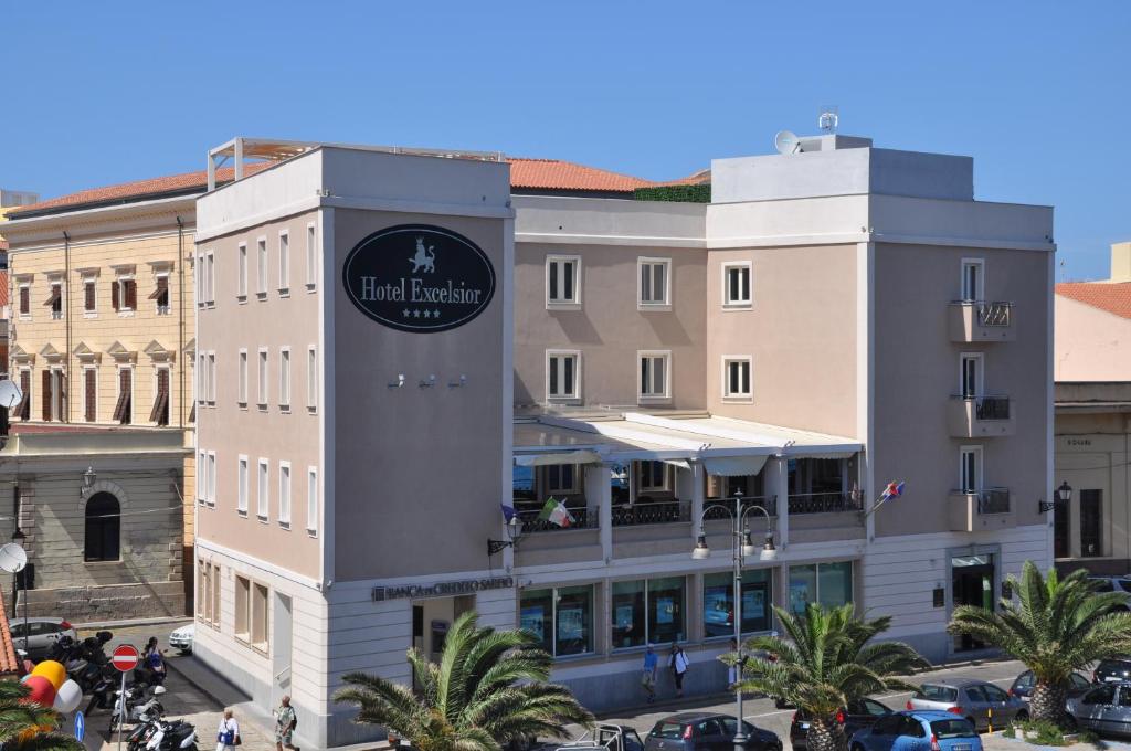 a large building with a clock on the front of it at Excelsior in La Maddalena