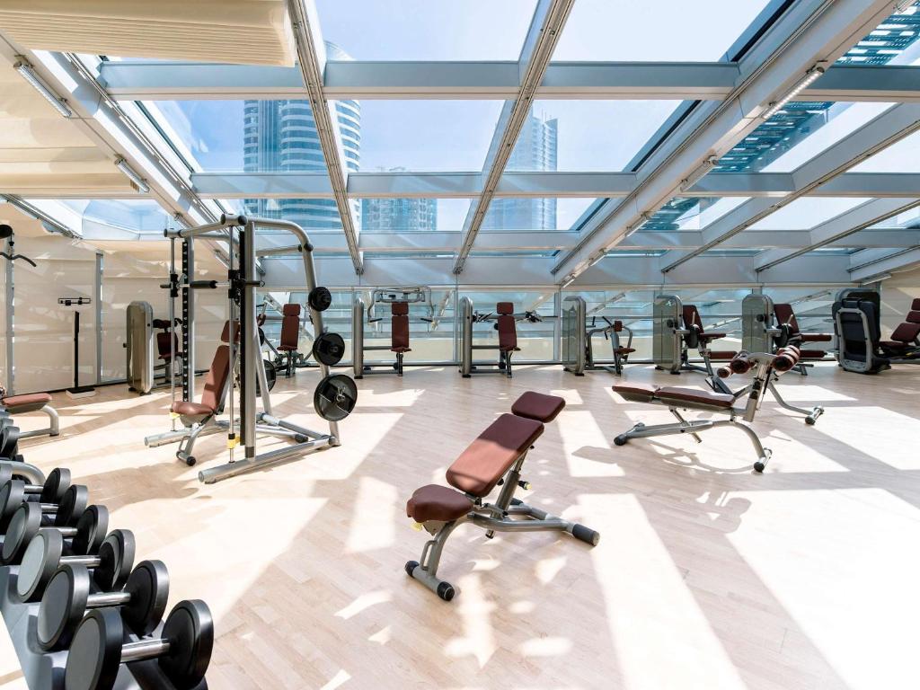 a gym with a lot of equipment in a building at Novotel Fujairah in Fujairah