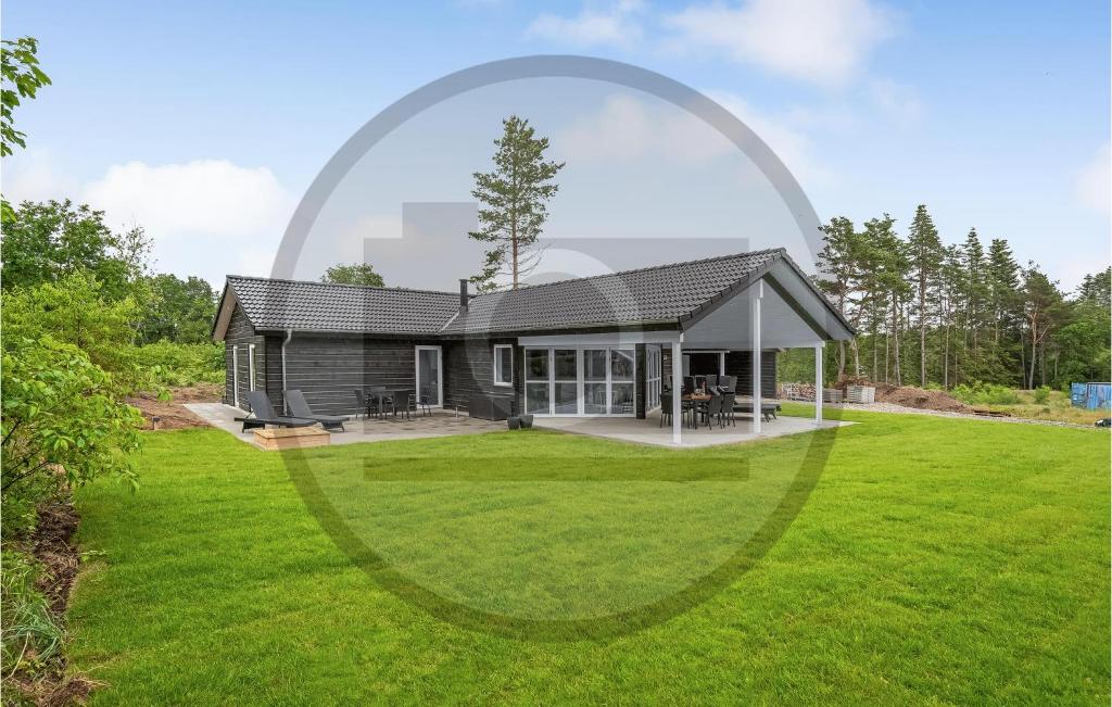 a house with a large lawn in front of it at 4 Bedroom Cozy Home In Ebeltoft in Ebeltoft