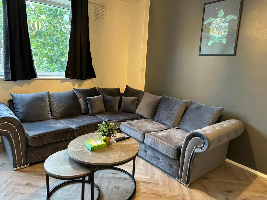 a living room with a couch and a table at Lux Apartment in Southwark in London