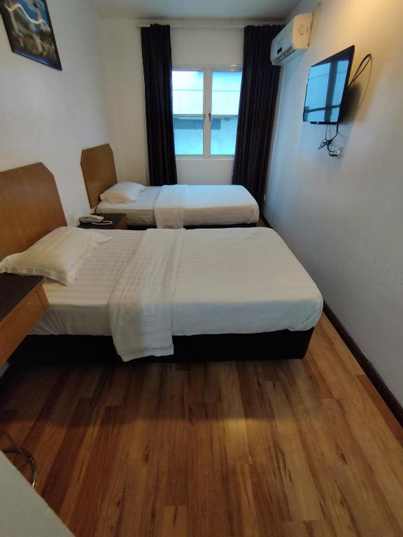 Postel nebo postele na pokoji v ubytování Marine Bay Hotel