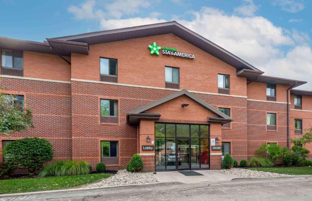 a large red brick building with a pharmacy at Extended Stay America Suites - Cleveland - Westlake in Westlake