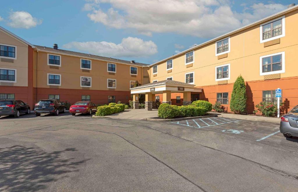 a large building with a parking lot in front of it at Extended Stay America Suites - Buffalo - Amherst in Amherst