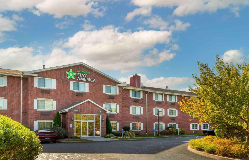 un gran edificio de ladrillo rojo con un hotel estrella en Extended Stay America Suites - Hartford - Farmington en Farmington